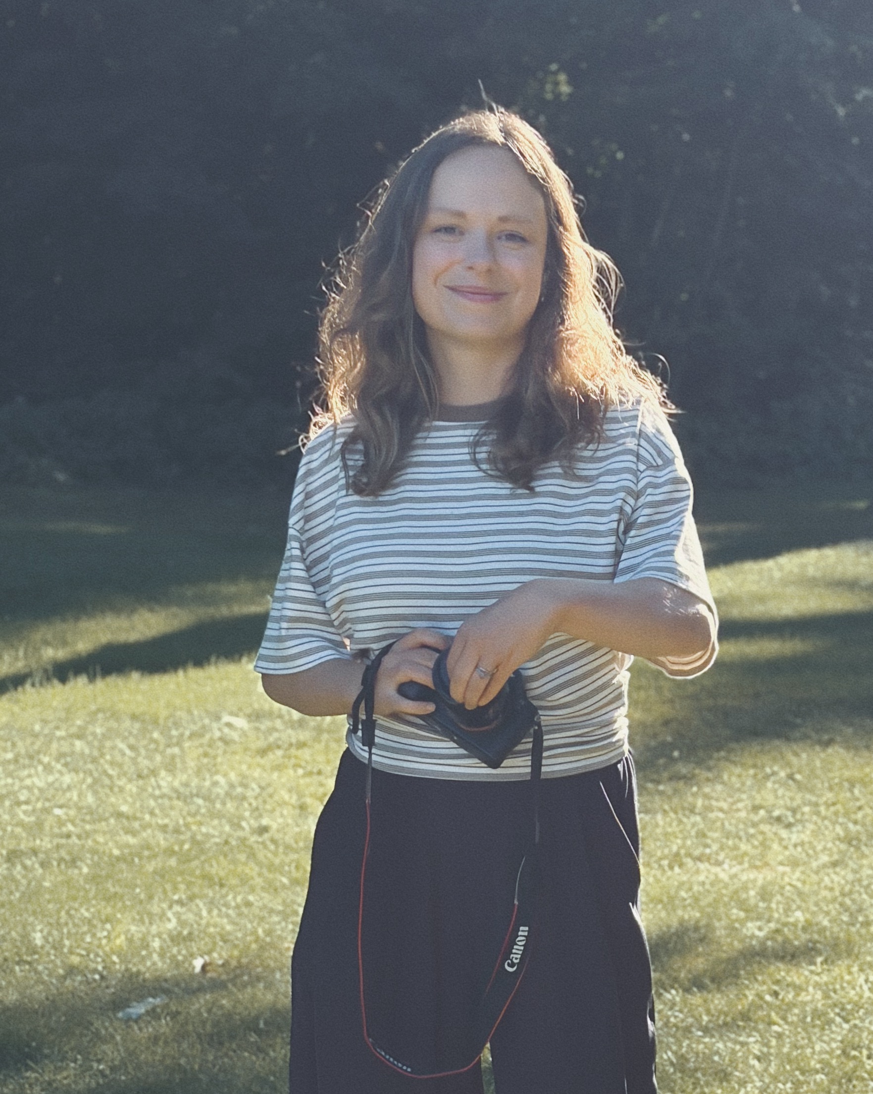 Anna Mudrenko holding her camera outdoors