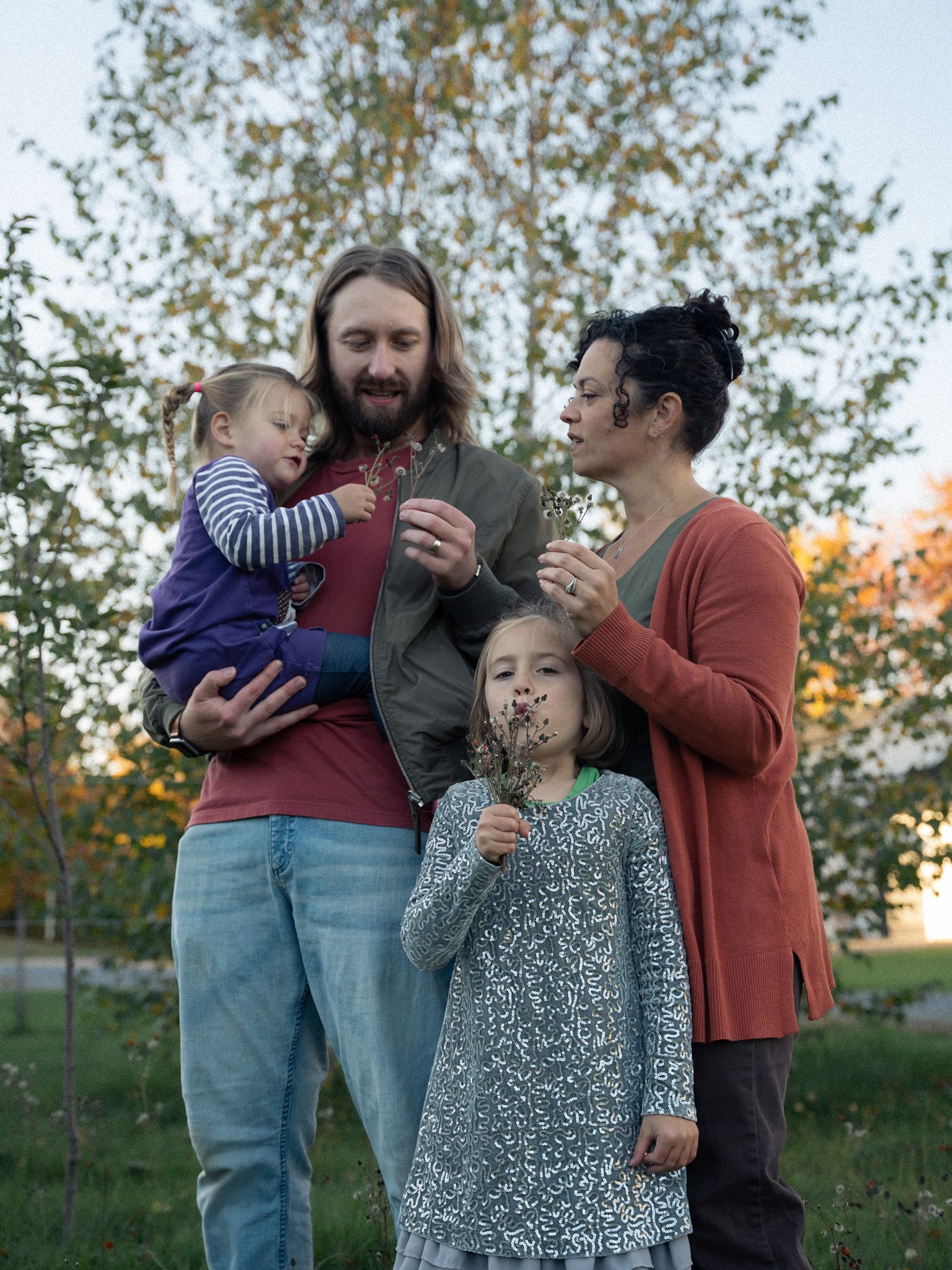 Parents and two children exploring wildflowers