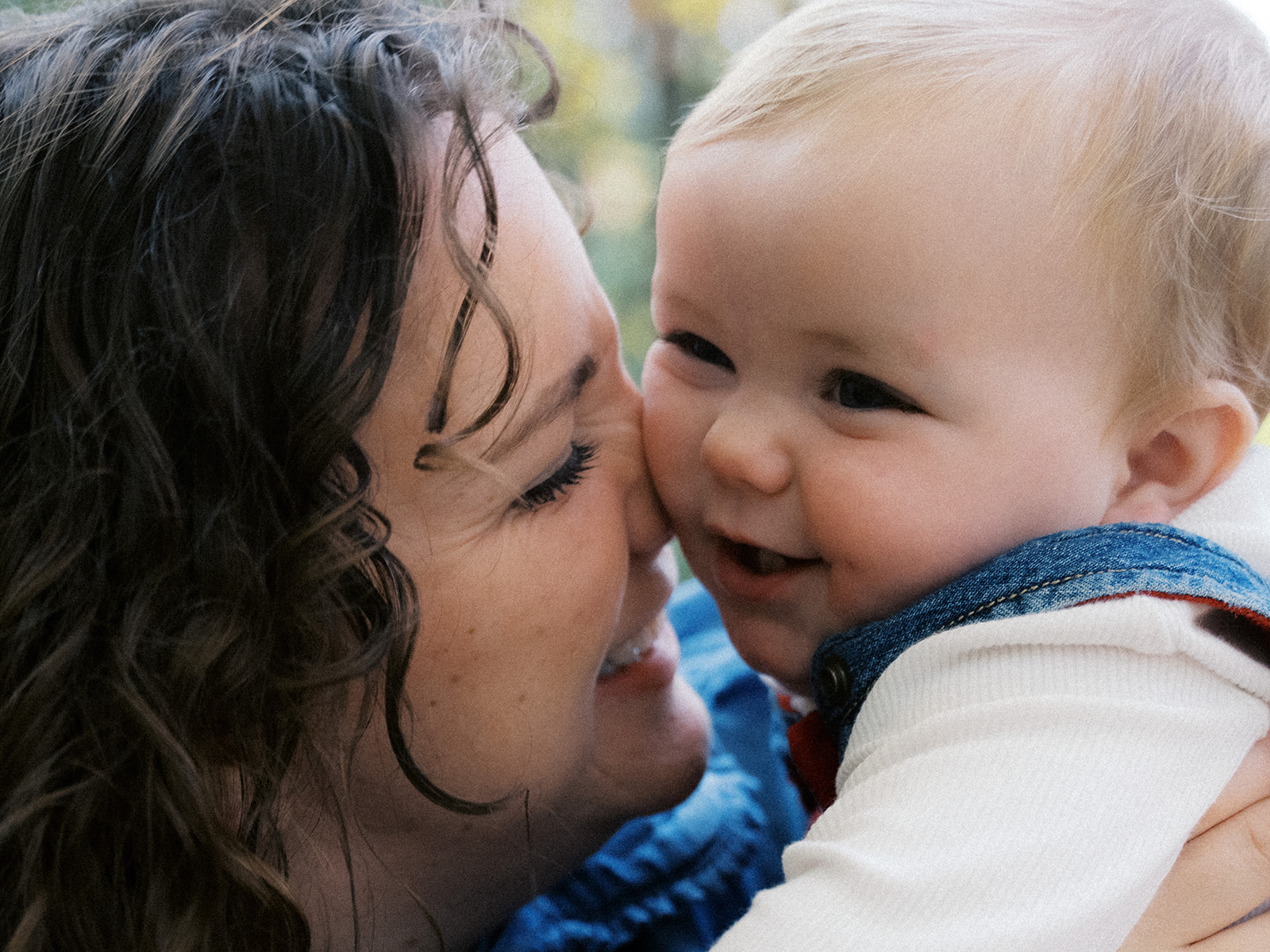 A mother kissing her baby
